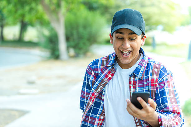 Finally great news about my university admission Young Student Reading an Email on his smartphone and seen excited about his university admission. Best Student Apps stock pictures, royalty-free photos & images
