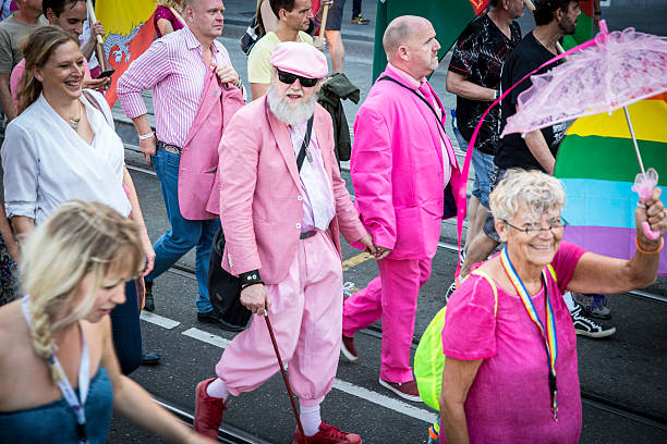 Amsterdam, the Netherlands - July 23, 2016: 2 old men holding hand at Pride Walk, demonstration parade from Vondelpark to Dam Square during Pink Saturday Gay Euro Pride celebrations