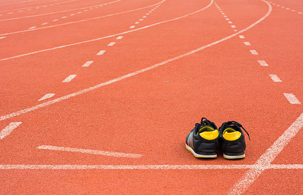 istock Sport shoes on running track background 584224986