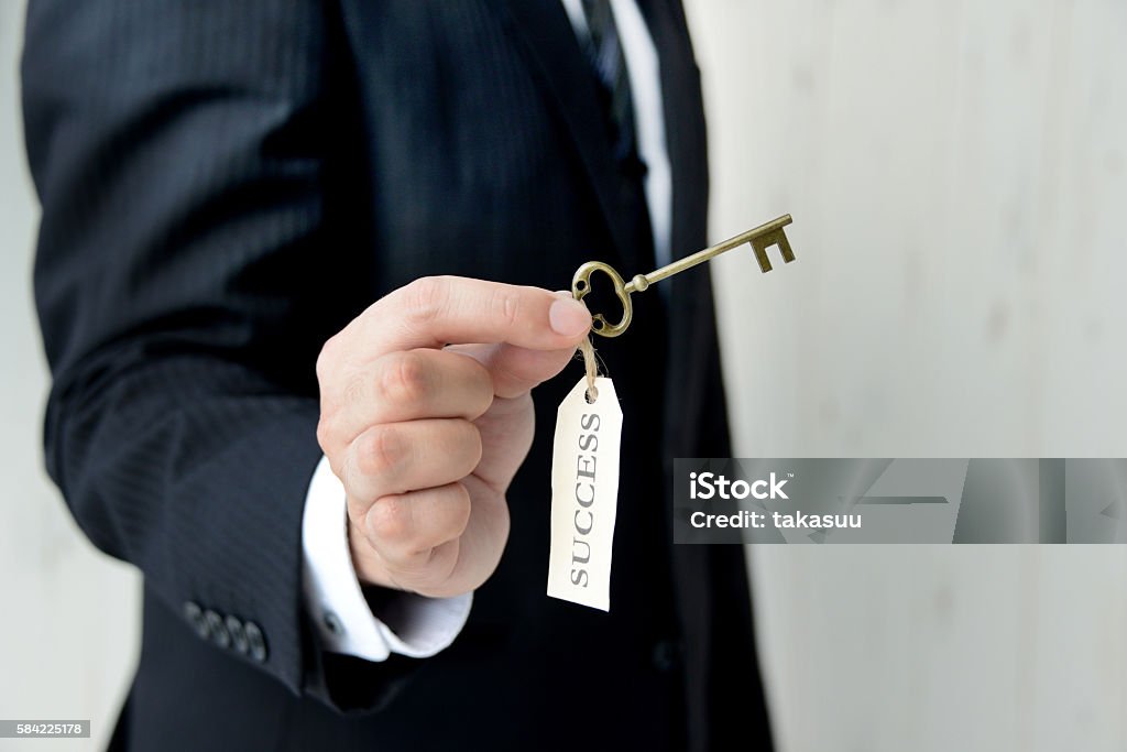 Businessman having key to success Success Stock Photo
