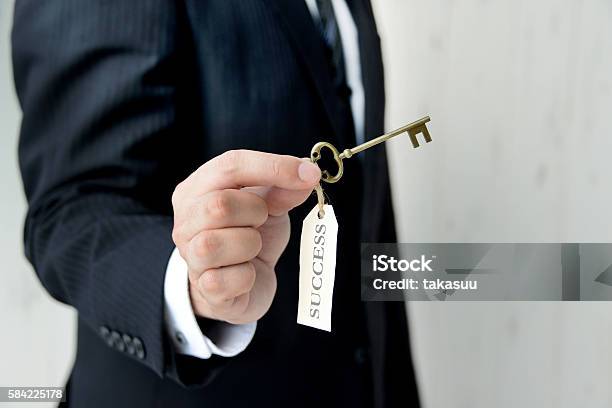 Businessman Having Key To Success Stock Photo - Download Image Now - Success, Mystery, Privacy