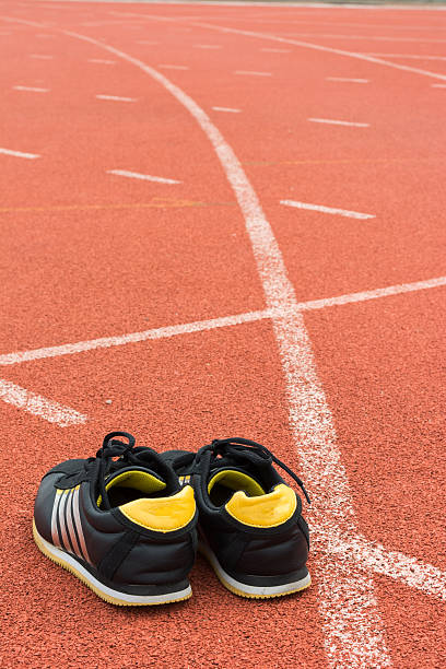 istock Sport shoes on running track background 584225320