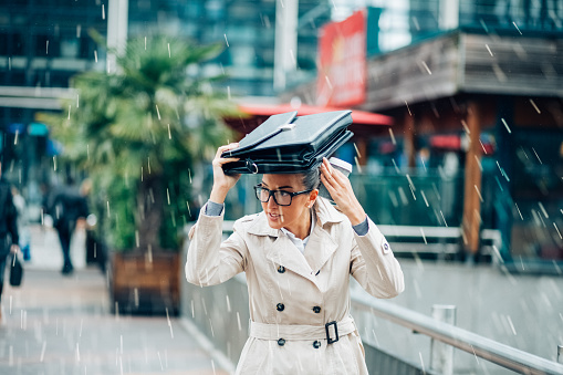 Young woman going to work on a rainy day