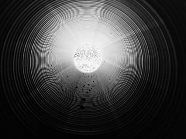 istock View inside of long plastic tube under ground. 584226798