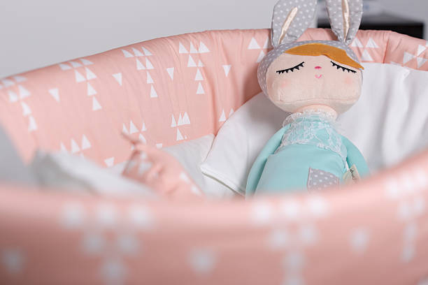 istock Toy ragdoll sleeping on a baby crib 584227886
