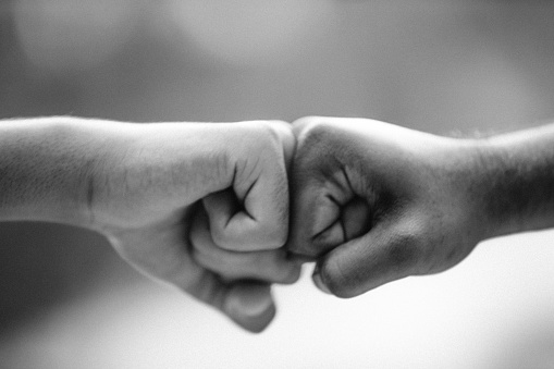 A fist bump (also called knuckle touch, power five, dap, pound, fist pound, spudding, fo' knucks, box, Bust,spuds, pound dogg, props, Bones, respect knuckles, bumping the rock, Brofist, Pound Cake, Sugar, Hooker fist, or knuckle crunching) is a gesture similar in meaning to a handshake or high five. A fist bump can also be a symbol of giving respect. It can be followed by various other hand and body gestures and may be part of a dap greeting. It is commonly used in baseball as a form of celebration with teammates, and with opposition players at the end of a game. In cricket it is a common celebratory gesture between batting partners.
