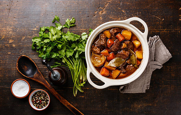 Beef meat stewed with potatoes in pot stock photo