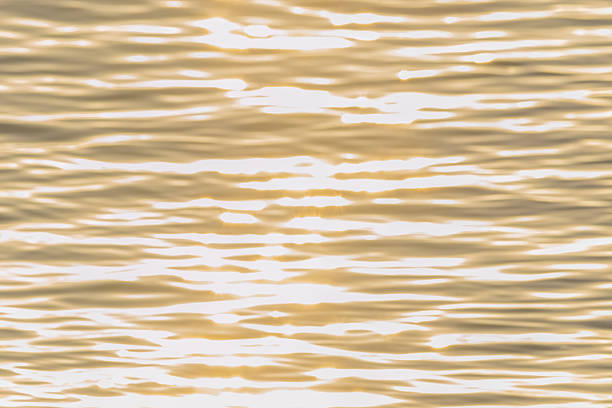 istock golden color water ripples. 584229696