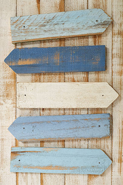 istock Old weathered blue and white wood sign arrows. 584231638