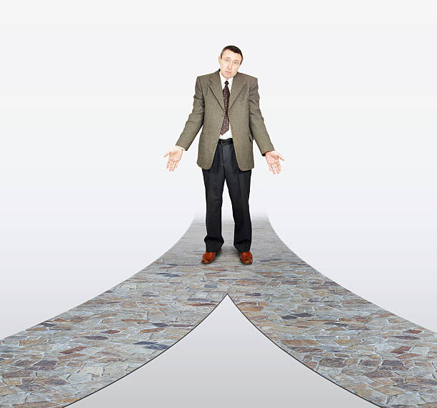 istock Frustrated businessman at the road fork 584231834