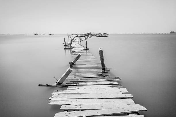 Water overflow on a broken wooden bridge in Penang, Malaysia