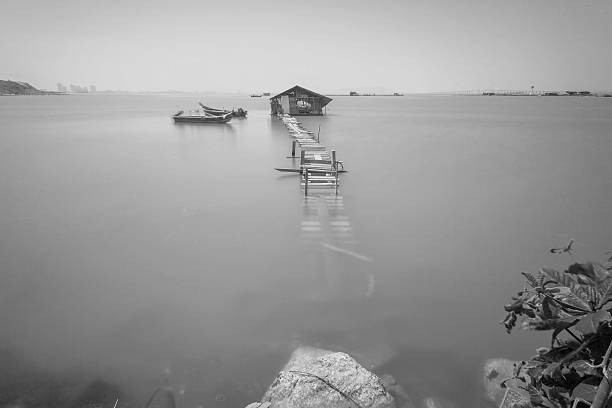 istock Water overflow on a broken wooden bridge and a hut 584232084