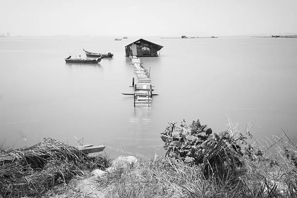 istock Water overflow on a broken wooden bridge and a hut 584232222
