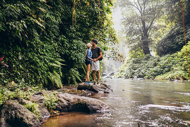 istock Couple kissing in forest creek 584233202