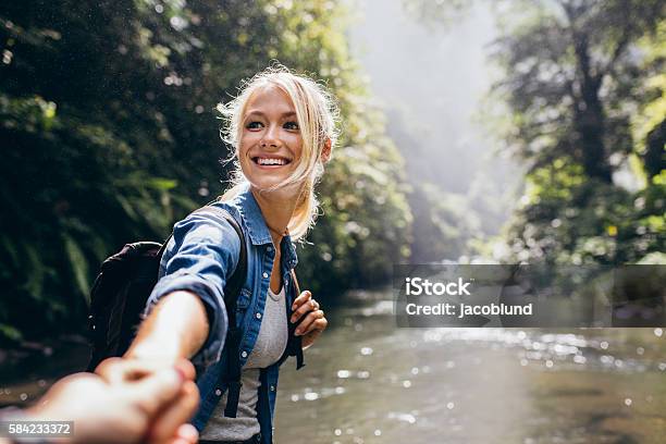 Hiker Woman Holding Mans Hand On A Nature Hike Stock Photo - Download Image Now - Hiking, Women, Couple - Relationship