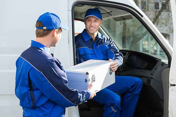 istock Happy Technician Giving Toolbox To Colleague 584233500