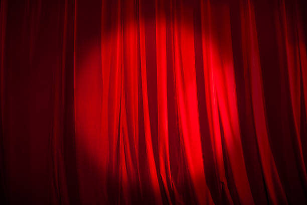 istock Spotlight on the Stage Curtain 584233868