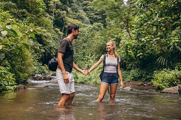 istock Loving young couple in forest stream 584234204