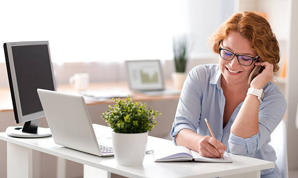 istock Cheerful smiling woman talking on cell phone 584234850