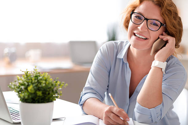 istock Joyful woman talking on cell phone 584234900
