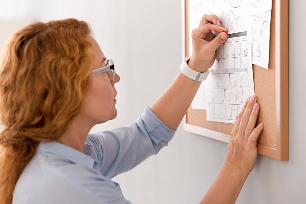istock Pleasant woman holding the calendar 584234972