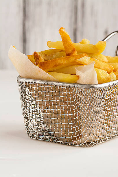 istock French fries in metal wire basket 584235498