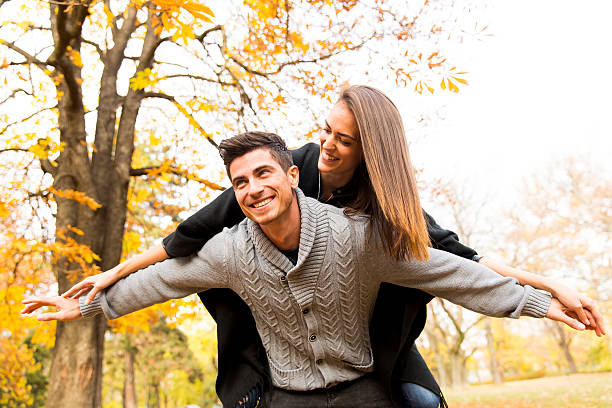 istock Couple in autumn park 584236254