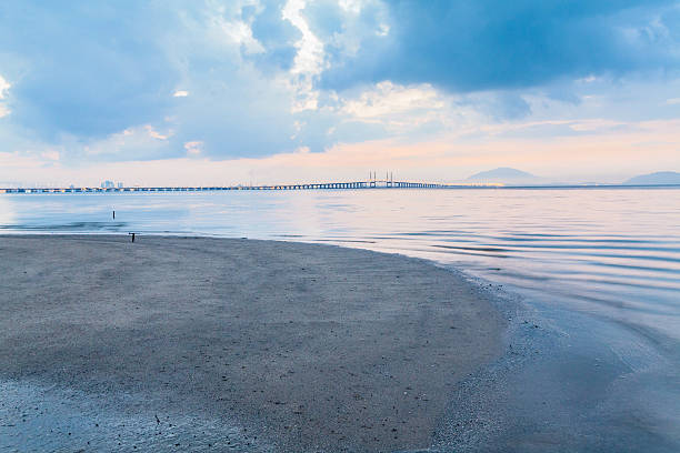 istock Sunrise by the shore with view of Penang Bridge 584237156