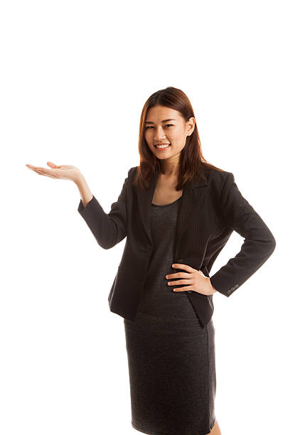 istock Young Asian business woman present with her hand. 584237486