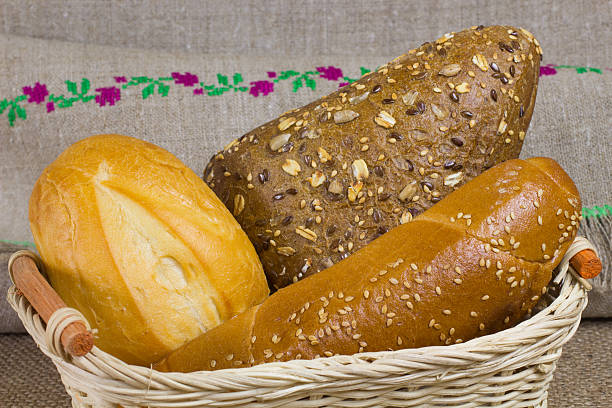 istock White bread, rolls sprinkled with seeds  in wicker basket 584238110