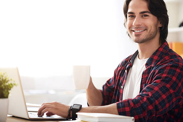 istock Positive man sitting at the table 584238924