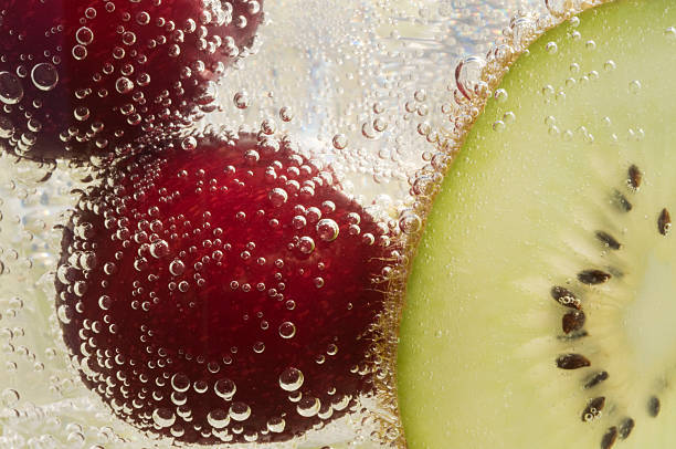 istock Beautiful cherries and kiwi in water with bubbles 584240660