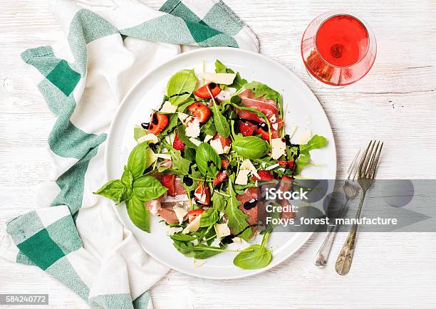 Summer Arugula Prosciutto Strawberry Salad With Glass Of Rose Wine Stock Photo - Download Image Now