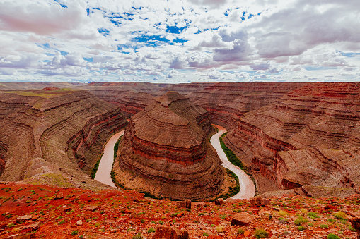 Gaze at the results of 300 million years of time, where the San Juan River winds and carves its way through the desert 1,000 feet below.