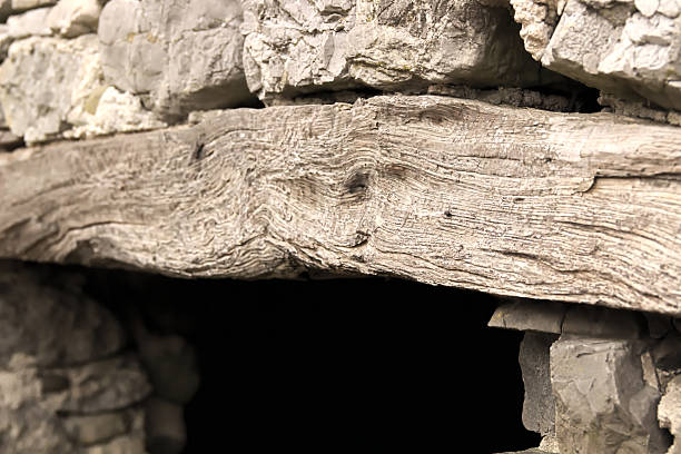 Wooden arcade, part of old house made from stone.