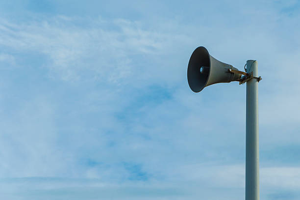 istock Isolated magaphone in a blue sky background 584243688
