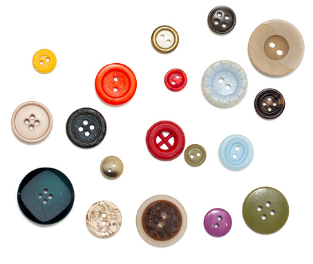 buttons of different size, shape and color over white