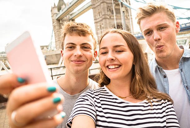 istock friends take a selfie in london - Tower bridge 584244710