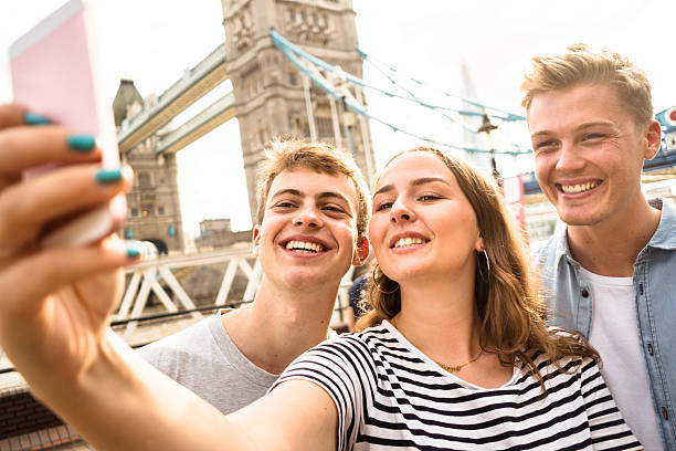 istock friends take a selfie in london - Tower bridge 584244902