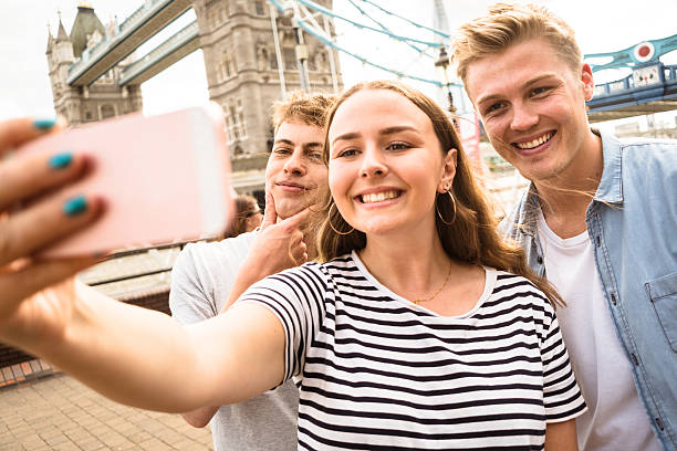istock friends take a selfie in london - Tower bridge 584244972