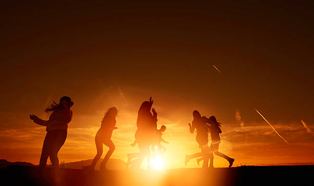 istock silhouettes of people in the sunset 584245516