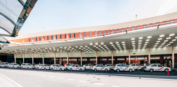 Barajas, Spain - July 11, 2016: A row of taxis waiting for clients at the main entrance of the T2 Terminal in Madrid Barajas - Adolfo Suárez airport in Madrid, Spain.