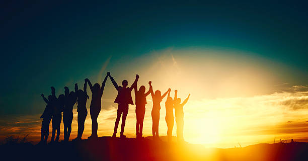 unity and friendship group of people holding hands and feeling together, arms raised in the sky, freedom, friendship and unity concept. arms outstretched photos stock pictures, royalty-free photos & images