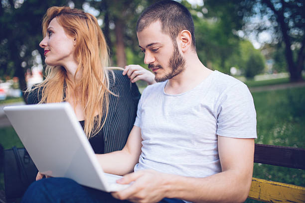 istock Couple on laptop in nature 584246636