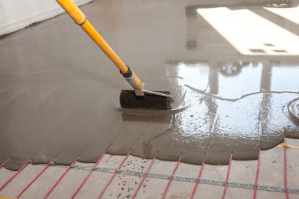 istock Electric floor heating system installation in new house. 584247322