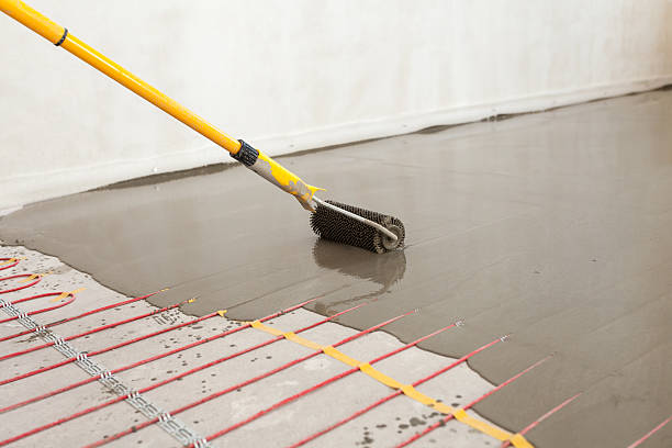 istock Electric floor heating system installation in new house. 584247486