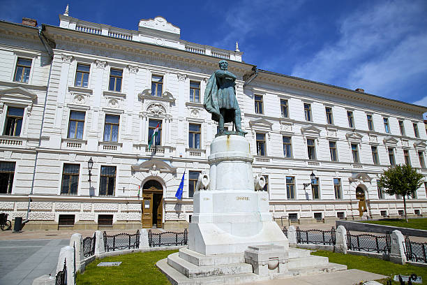 istock Statue of Lajos Kossuth and governmental building in Pecs, Hungary. 584248412