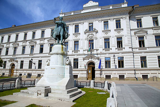 istock Statue of Lajos Kossuth and governmental building in Pecs, Hungary. 584248416