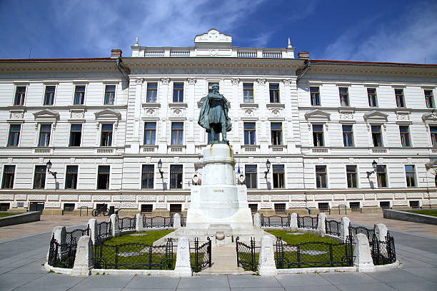 istock Statue of Lajos Kossuth and governmental building in Pecs, Hungary. 584248476