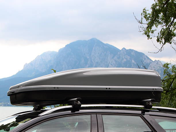 istock Car Rooftop Box with Mountain and Lake in Background 584248714